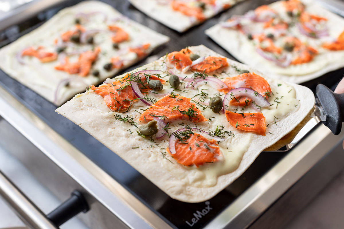Flammkuchenböden mit crème fraîche, Lachs, Kapern, Dill, Rote Zwiebeln auf LeMax Grill